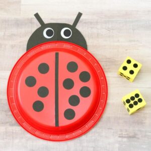 Bug and butterfly math activities for preschool. Roll the foam dice and put the correct number of dots on the paper plate ladybug.