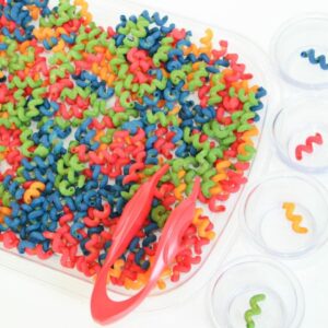 Colorful pasta sensory bin preschool color activity.
