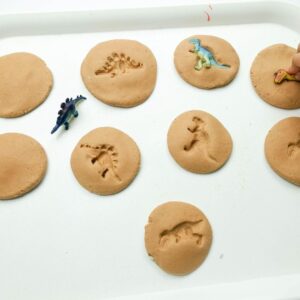 Dinosaur preschool activity dinosaur imprints into playdough