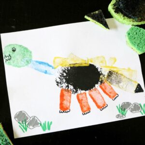 Dinosaur preschool activity painting a dinosaur with sponges