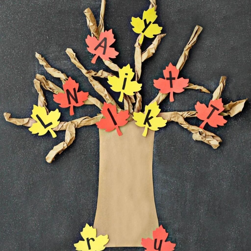 fall tree made from construction paper with leaves that have letters written on them